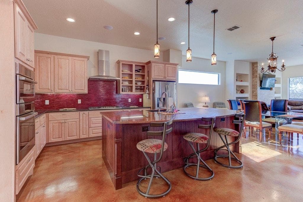 Large kitchen with Island.  Kitchen is stocked with pots, pans, plates, utensils...everything you need to cook.